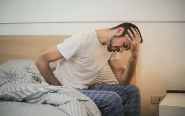 Man suffering a headache due to a TBI (Traumatic Brain Injury).
