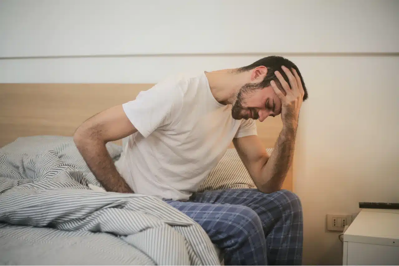 Man suffering a headache due to a TBI (Traumatic Brain Injury).