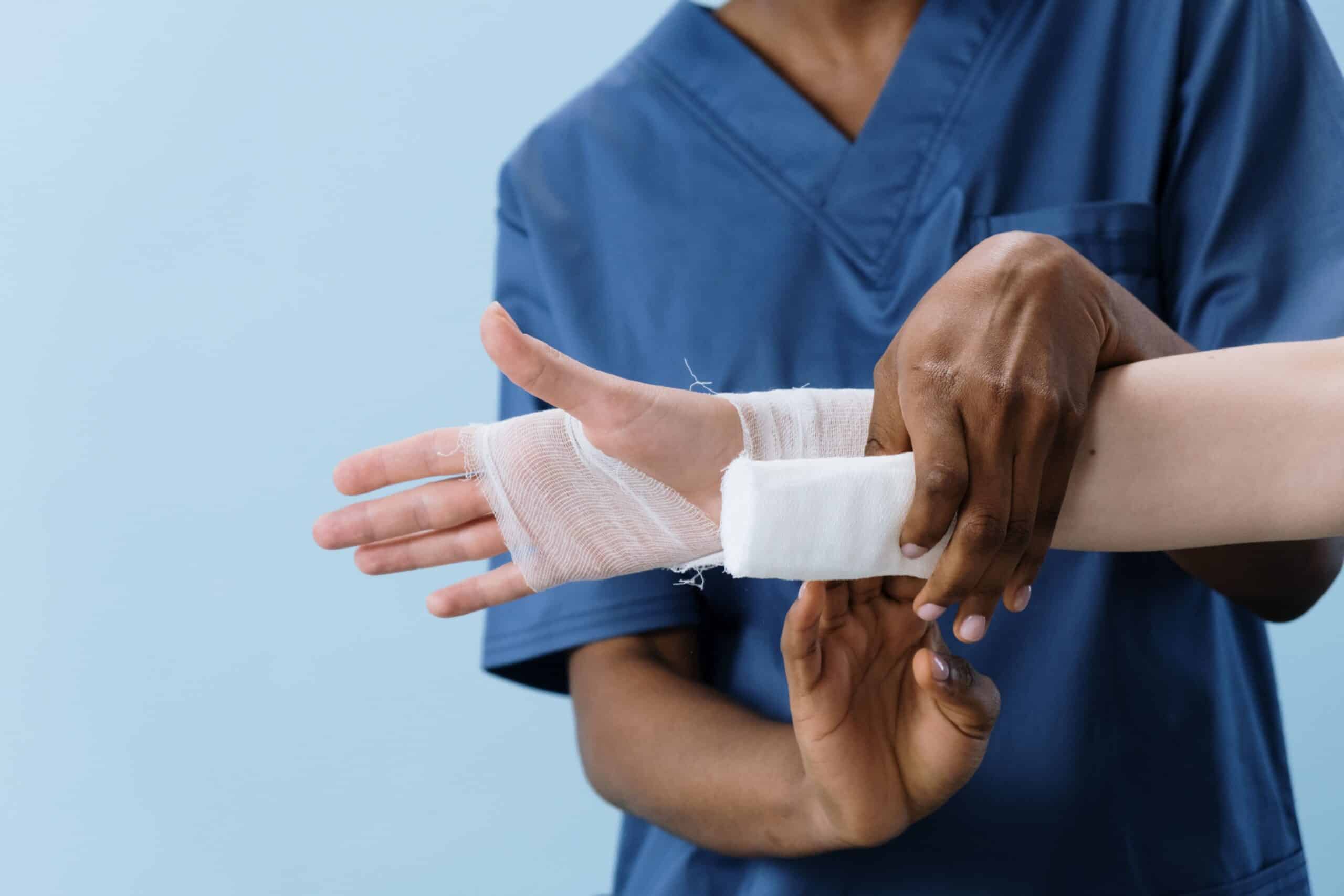 A nurse wrapping a patient's wrist.
